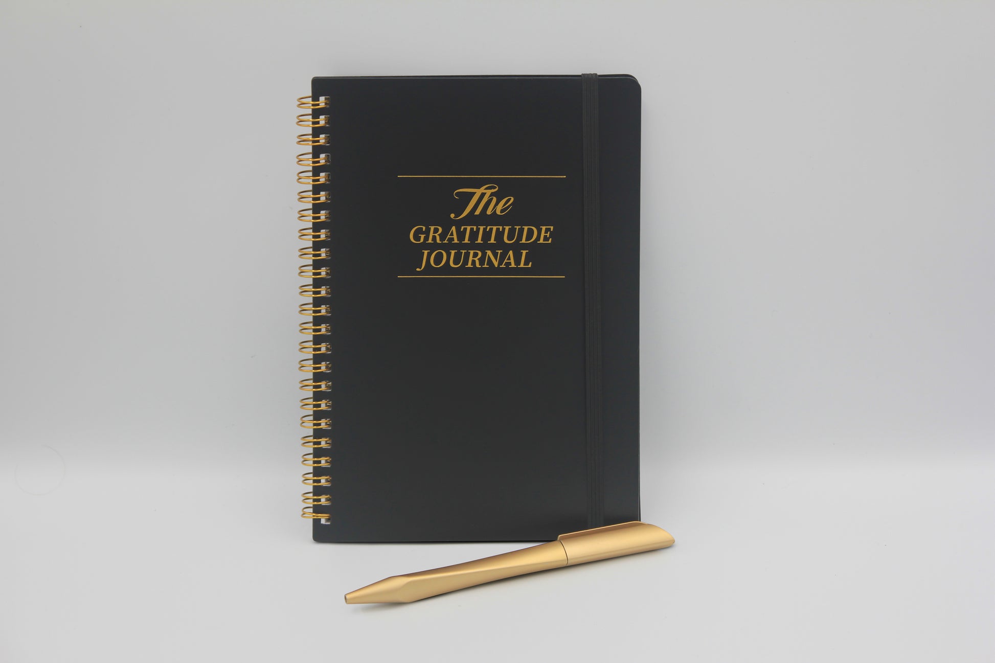 Gratitude Journal til mænd med gylden spiral og pen - designet til daglig refleksion og mental ro.