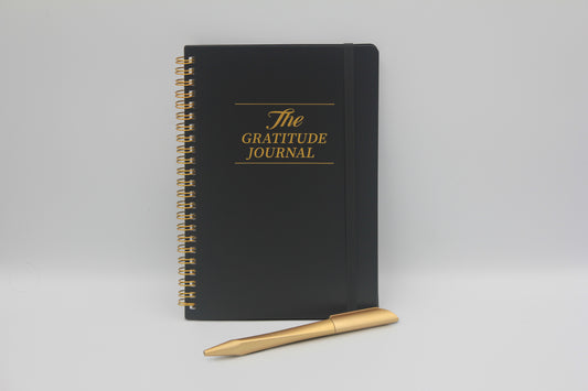 Gratitude Journal til mænd med gylden spiral og pen - designet til daglig refleksion og mental ro.